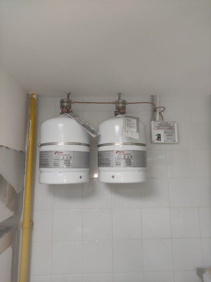 Two Kidde WHDR cylinders installed on a kitchen wall