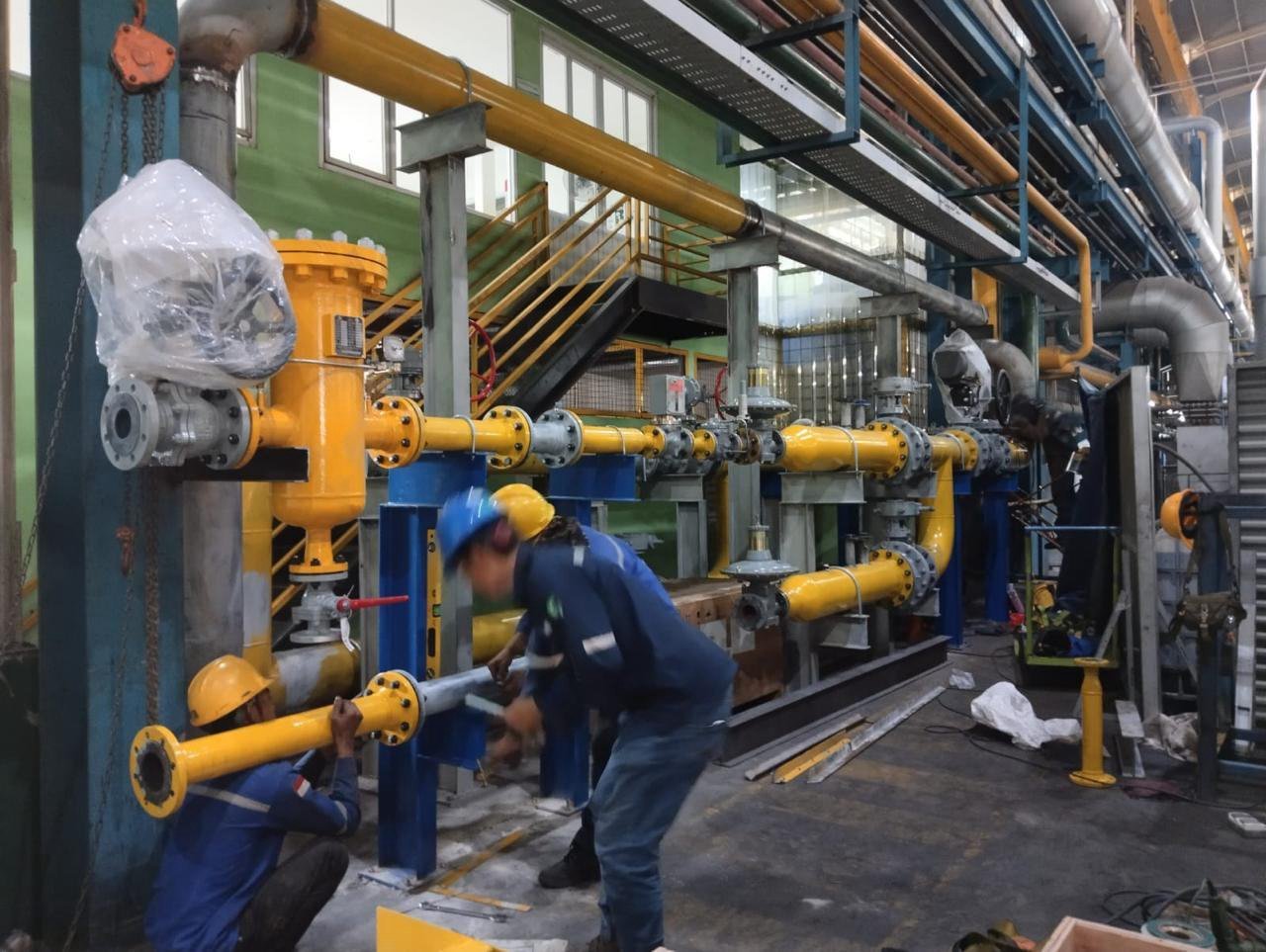 Technicians installing industrial gas piping